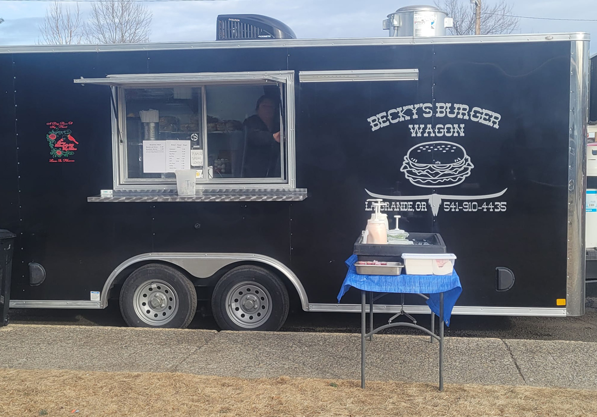 Becky's Burger Wagon Setup for an event with Becky just visible through the window.